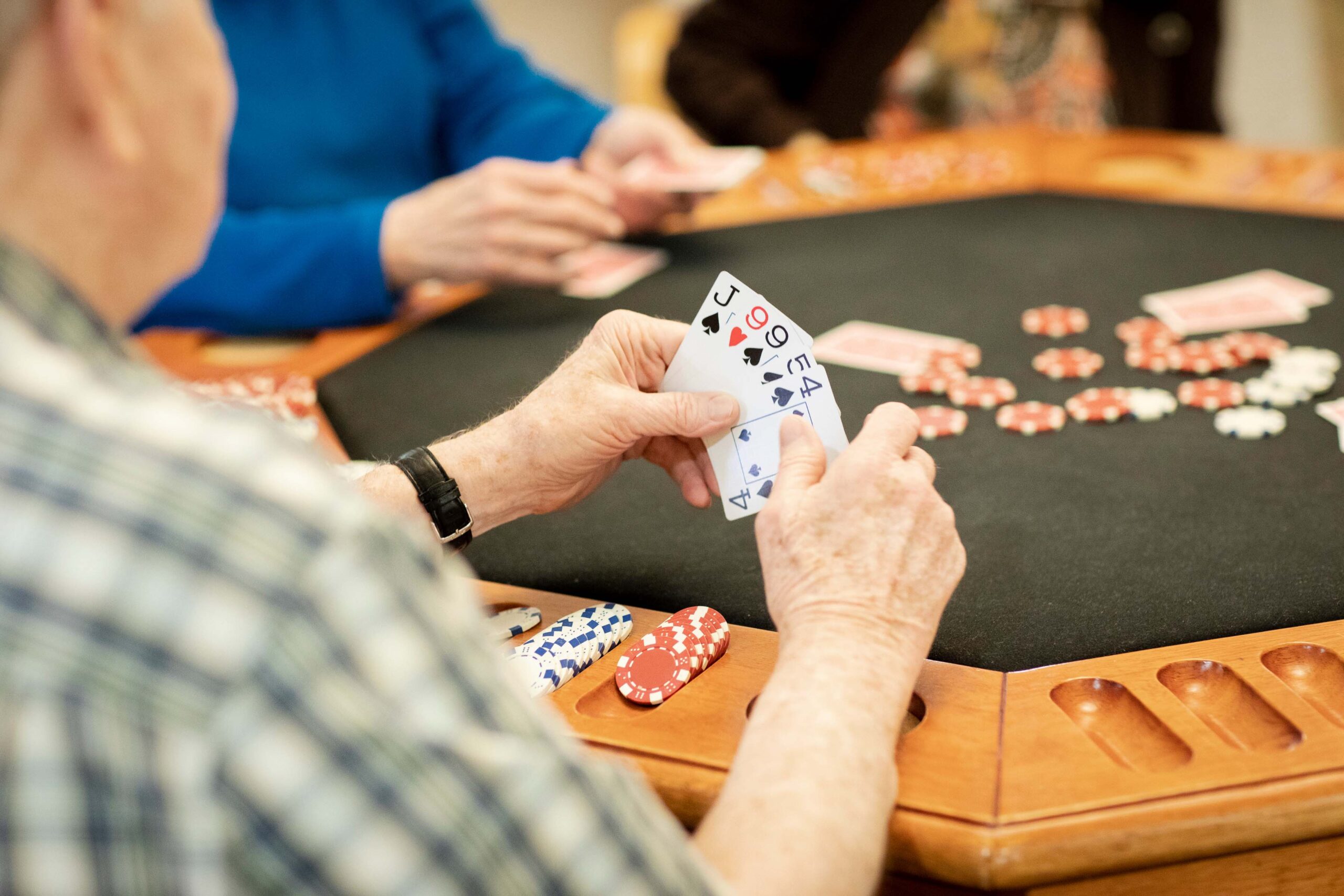 Grace_Management_Memphis_2018-3771-2 - Point Pleasant A senior man sits at a poker table with friends at Point Pleasant, a senior living community near Pittsburgh.